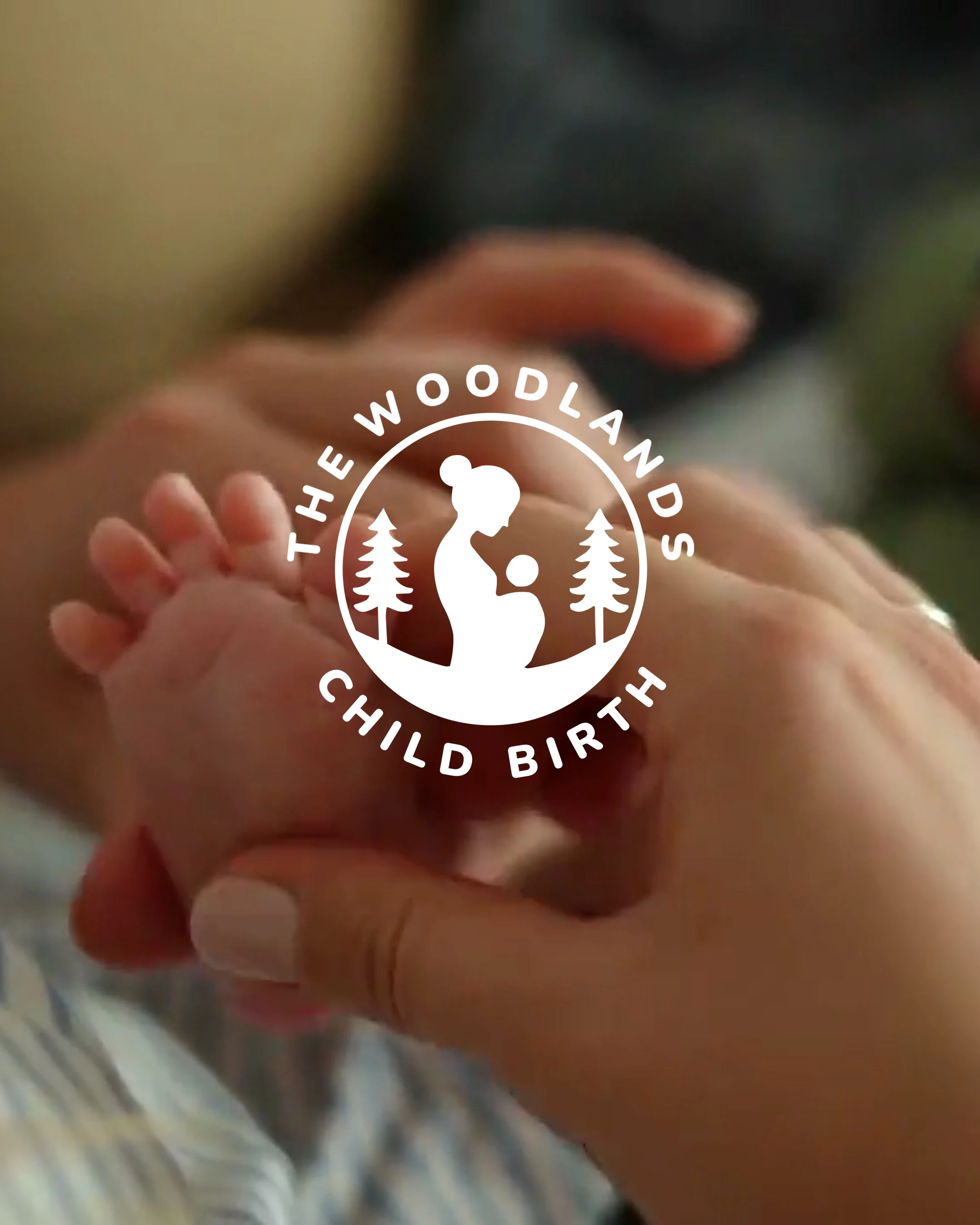 The Woodlands Child Birth homepage featuring its logo over a close-up of a newborn’s feet.